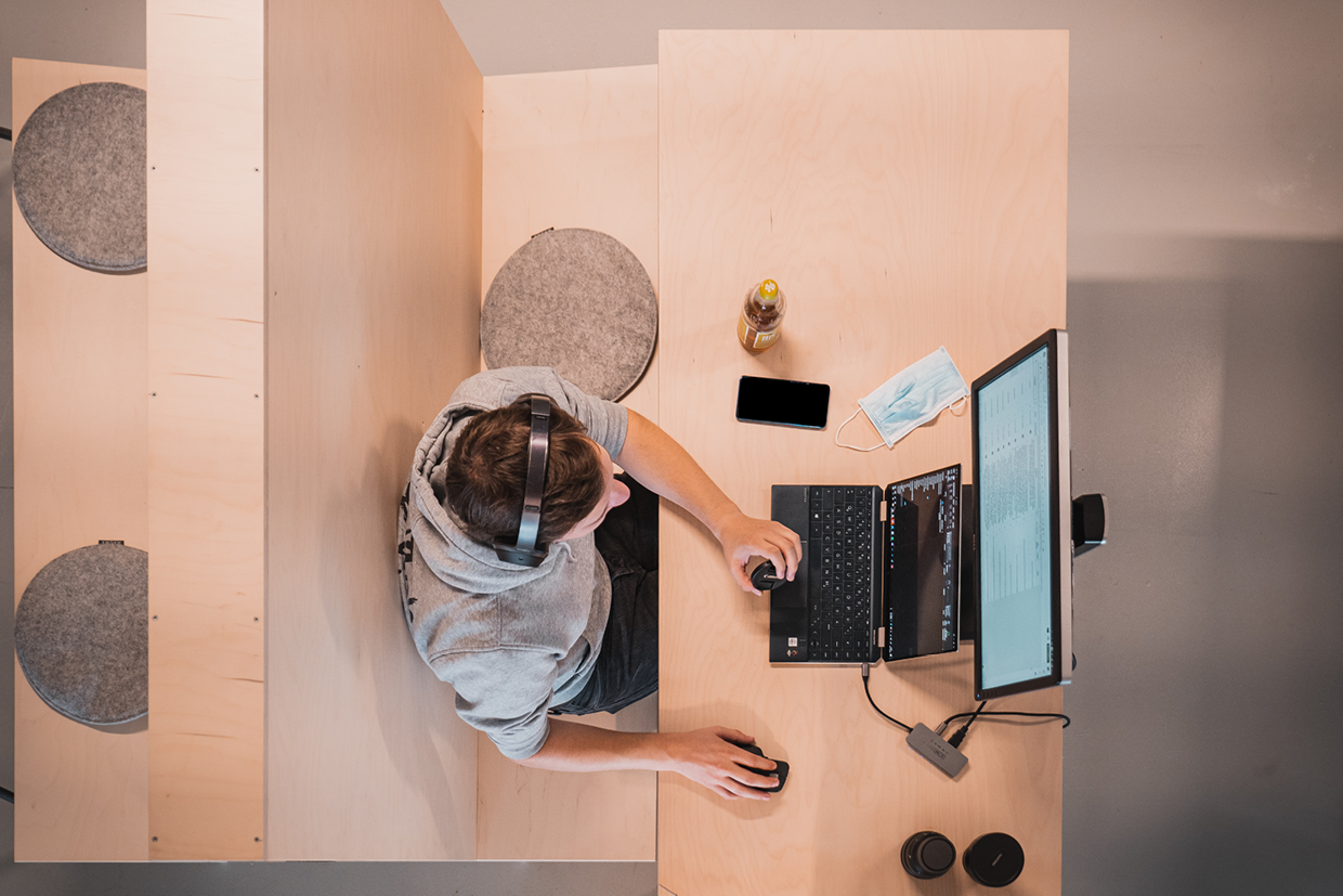 Man working in booth - 1240x827px